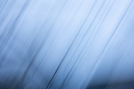 Blurry gray bokeh with soft shimmer. Abstract blurred gray background with radial gradient.の写真素材