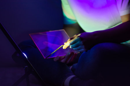 Attractive woman in white shirt with digital tablet surrounded by colorful bright work ambiance....