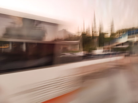 Central bus terminus with people blurry background. Bus station and passengers on the street blur defocus image.の写真素材