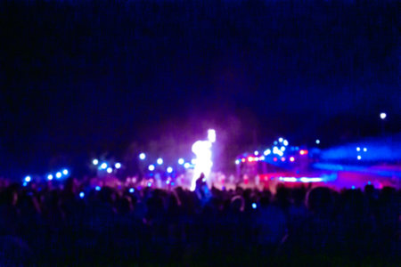 Joyful people dancing at community event bokeh texture. Guests having fun at music festival outdoors.の写真素材
