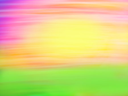 Spring fields with green grass and colorful bright sunset blurred texture. Colorful pink and orange sun is coming up from over the hill defocused backdrop.の写真素材