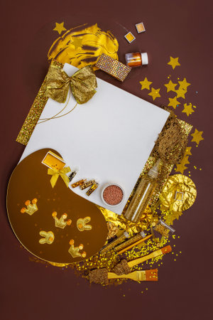 Golden colored materials for creative work on the table. Mock up notebook album and golden objects for painting top view. Golden materials used for crafts and art.の写真素材