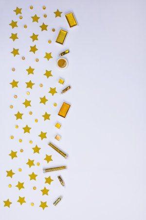 Frame border made of shining glitter and gold paint for creative projects. Fairy abstract glowing glitter on a white background.の写真素材