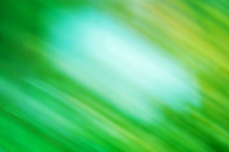 Green sparks flying around. Green colorful lights swirling around colored background.の写真素材