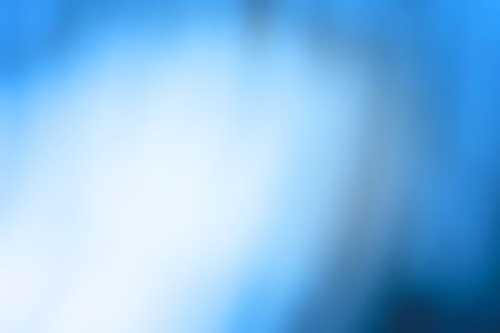 Bright glow radiance on blue blurred bokeh background. Shimmering glow sheen on blurred background.の写真素材