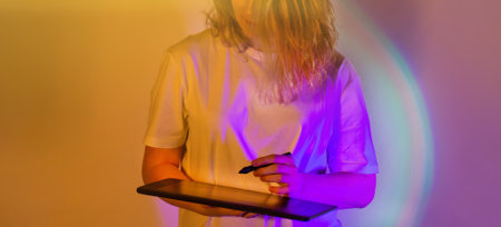 Modern digital painting and illustration concept. Girl modern digital artist create her new art project. Drawing in virtual reality using special art equipment.の写真素材