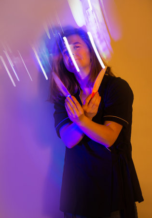 Personal hygiene and manicure. Portrait of a beauty industry master on colored backgrounds in neon light.の写真素材