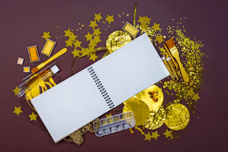Notebook mockup background for design. Drawing golden tools and creative supplies. Colorful golden art supplies.の写真素材