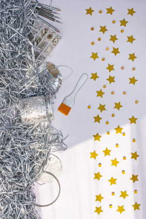 Boxes with silver plated beads. Silver plated Accessories for needlework on table. Working process making jewelry.の写真素材