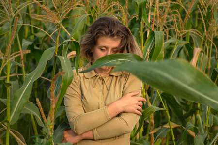 Loneliness and mystery art photography. Beautiful stylish woman walking in sunset light in green...