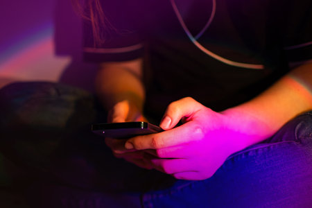Excited young lady holding trendy smartphone. Beautiful and cute girl using smartphone.の写真素材