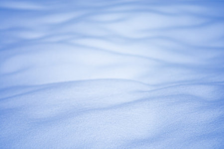 Winter bright falling snow texture. Fresh snow cover closeup.