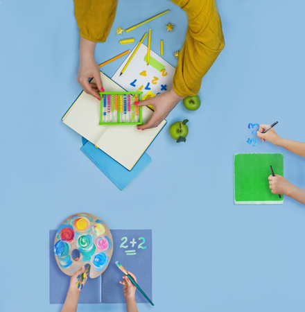 Mothers and childrens hands drawing at the table. Family mother and childs together paint. Family drawing concept.の写真素材
