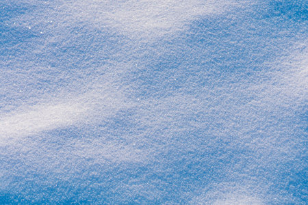 Shiny white snow texture on a winter sunny day.