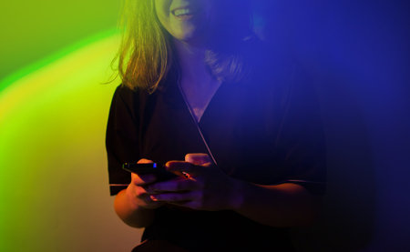 Searching or social networks concept. Using smartphone for social media and game. Young woman chatting online through gadgets.の写真素材