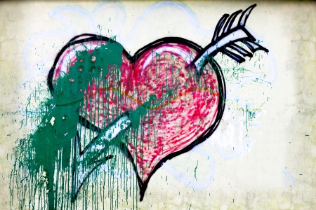 Painted red heart on dark grey grunge concrete and cement wall, Valentineの写真素材