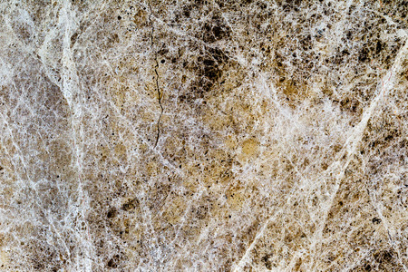 beautiful old yellow-brown decorative stone marble abstract cracks and stains on the surface as natural backgroundの写真素材