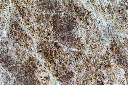 beautiful old yellow-brown decorative stone marble abstract cracks and stains on the surface as natural backgroundの写真素材