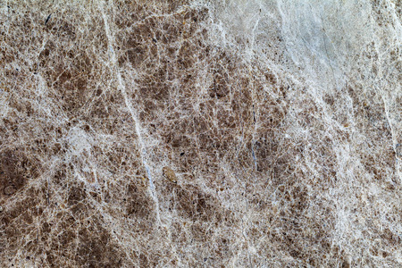 beautiful old yellow-brown decorative stone marble abstract cracks and stains on the surface as natural backgroundの写真素材