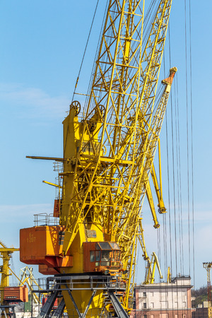 ODESSA, UKRAINE - APRIL 15: industrial large sea cargo cranes in the dock harbor of Odessa sea trading port cargo loading marine vessel in the Odessa seaport cargo container terminal, April 15, 2014 Odessa, Ukraine のeditorial素材