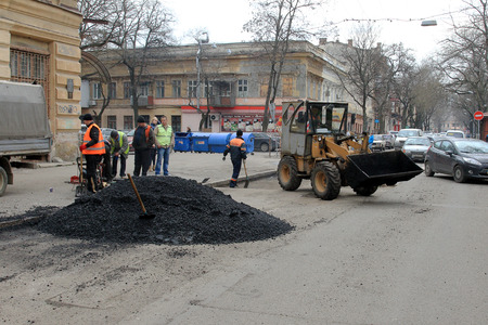 Odessa - April 3: a team of workers repairs road under the program of urban planning repairs after winter frosts that destroyed an asphalt road . April 3, 2014 in Odessa, Ukraineのeditorial素材