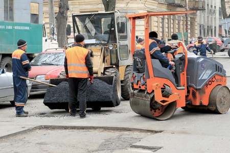 Odessa - April 3: a team of workers repairs road under the program of urban planning repairs after...