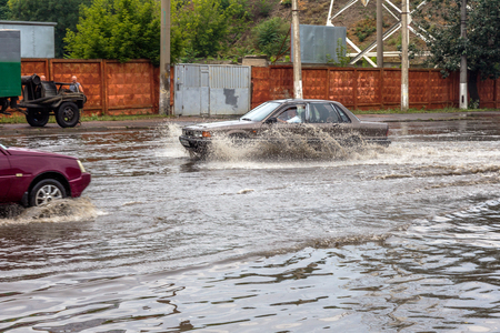 ODESSA, UKRAINE - July 24, 2014: As a result of heavy rainfall disaster flooded streets. Cars fording. Flooding. July 24, 2014 in Odessa, Ukraine のeditorial素材