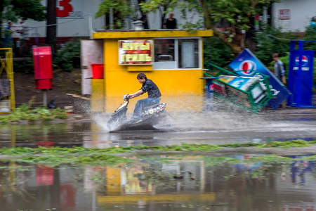 ODESSA, UKRAINE - July 24, 2014: As a result of heavy rainfall disaster flooded streets. Cars fording. Flooding. July 24, 2014 in Odessa, Ukraine のeditorial素材