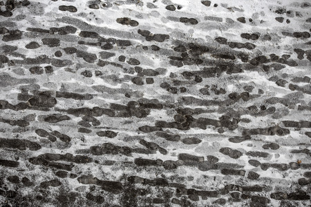 Creative unusual abstract background from the set of traces of human foot prints and the wheels of cars in the snow - the danger of traveling over snow.の写真素材