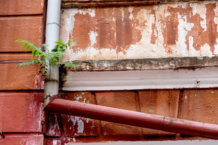 An old destroyed wall with large large cracks. Background of crack on an old wall as background for creative design. Destroyed cracked wall of building after earthquake and hurricaneの写真素材