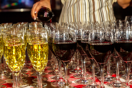 Bright abstract background of glass goblets with wine. Unusual bright abstract background of wine strings for decoration of a restaurant. Selective not deep focus, blurの写真素材
