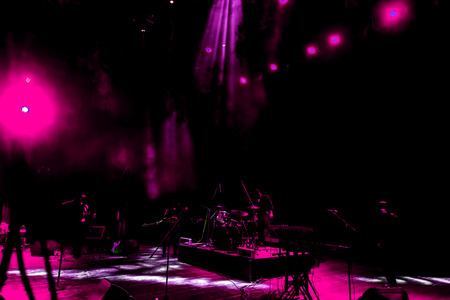 Stage lights. Several projectors in the dark. Multi-colored light beams from the stage spotlights on the stage in the smoke at the time of the entertainment show. Night club. Lights show. Lazer showの写真素材