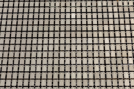 The kinetic facade of the building. Stainless steel metal plates hang freely and sway in the wind....