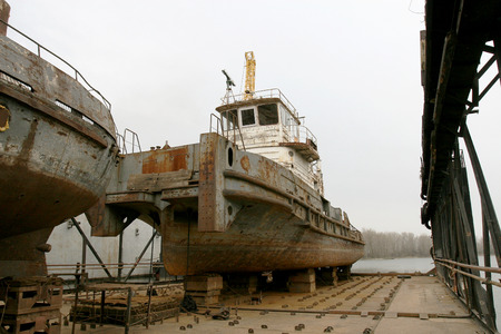 Archive 2008 River port of Ust-Danube was destroyed in of crisis. Old rusty boats on stocks in dry dock of river port. Old river vessels rust on dock repair shop stocks for repair of river vesselsの写真素材