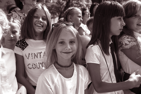 ODESSA, UKRAINE September 1, 2018: September 1, day of the celebration of knowledge. Smiling happy first graders and their happy parents. Teacher in schoolyard holiday Beginning of the training yearのeditorial素材