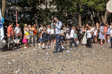 ODESSA, UKRAINE September 1, 2018: September 1, day of the celebration of knowledge. Smiling happy first graders and their happy parents. Teacher in schoolyard holiday Beginning of the training yearのeditorial素材