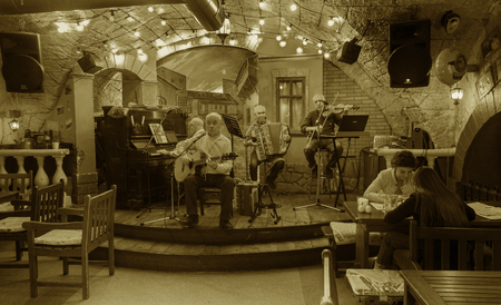 ODESSA, UKRAINE - October 15, 2018: Muskakanty jazz groups play old gangster traditional jazz-blues song in the famous Gambrinus tavern in the basement of the catacombs on Deribasovskaya in Odessaのeditorial素材