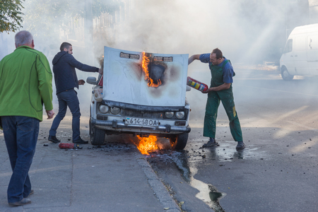 ODESSA, UKRAINE - Oct. 13 2018: Burning car in middle of highway. Sudden Fire from short circuit wiring an old car. Fire in engine compartment began to absorb entire old car is on fire. Road accidentのeditorial素材