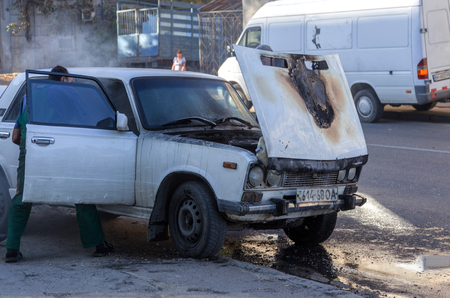 ODESSA, UKRAINE - Oct. 13 2018: Burning car in middle of highway. Sudden Fire from short circuit wiring an old car. Fire in engine compartment began to absorb entire old car is on fire. Road accidentのeditorial素材