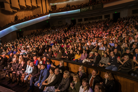 Odessa, Ukraine - November 4, 2018: Large crowd of spectators with pleasure in theater, at concert Celentano tribute during a creative light and musical show. Cheerful bright show in the party clubのeditorial素材