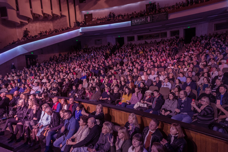Odessa, Ukraine - November 4, 2018: Large crowd of spectators with pleasure in theater, at concert Celentano tribute during a creative light and musical show. Cheerful bright show in the party clubのeditorial素材
