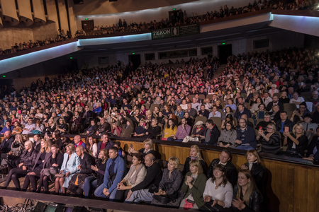 Odessa, Ukraine - November 4, 2018: Large crowd of spectators with pleasure in theater, at concert Celentano tribute during a creative light and musical show. Cheerful bright show in the party clubのeditorial素材