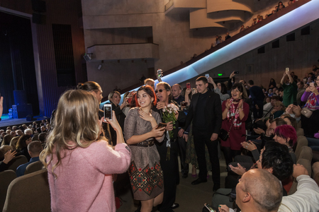 Odessa, Ukraine - November 4, 2018: Large crowd of spectators with pleasure in theater, at concert Celentano tribute during a creative light and musical show. Cheerful bright show in the party clubのeditorial素材
