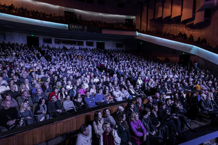Odessa, Ukraine - November 4, 2018: Large crowd of spectators with pleasure in theater, at concert Celentano tribute during a creative light and musical show. Cheerful bright show in the party clubのeditorial素材