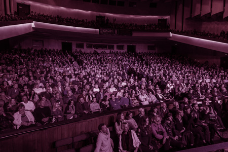 Odessa, Ukraine - November 4, 2018: Large crowd of spectators with pleasure in theater, at concert Celentano tribute during a creative light and musical show. Cheerful bright show in the party clubのeditorial素材