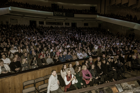 Odessa, Ukraine - November 4, 2018: Large crowd of spectators with pleasure in theater, at concert Celentano tribute during a creative light and musical show. Cheerful bright show in the party clubのeditorial素材