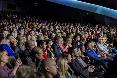 Odessa, Ukraine - November 4, 2018: Large crowd of spectators with pleasure in theater, at concert Celentano tribute during a creative light and musical show. Cheerful bright show in the party clubのeditorial素材