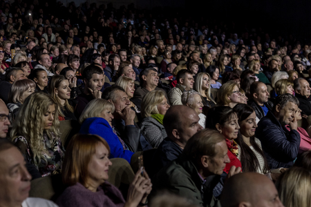 Odessa, Ukraine - November 4, 2018: Large crowd of spectators with pleasure in theater, at concert Celentano tribute during a creative light and musical show. Cheerful bright show in the party clubのeditorial素材