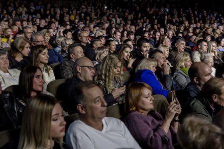 Odessa, Ukraine - November 4, 2018: Large crowd of spectators with pleasure in theater, at concert Celentano tribute during a creative light and musical show. Cheerful bright show in the party clubのeditorial素材