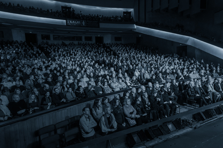 Odessa, Ukraine - November 4, 2018: Large crowd of spectators with pleasure in theater, at concert Celentano tribute during a creative light and musical show. Cheerful bright show in the party clubのeditorial素材
